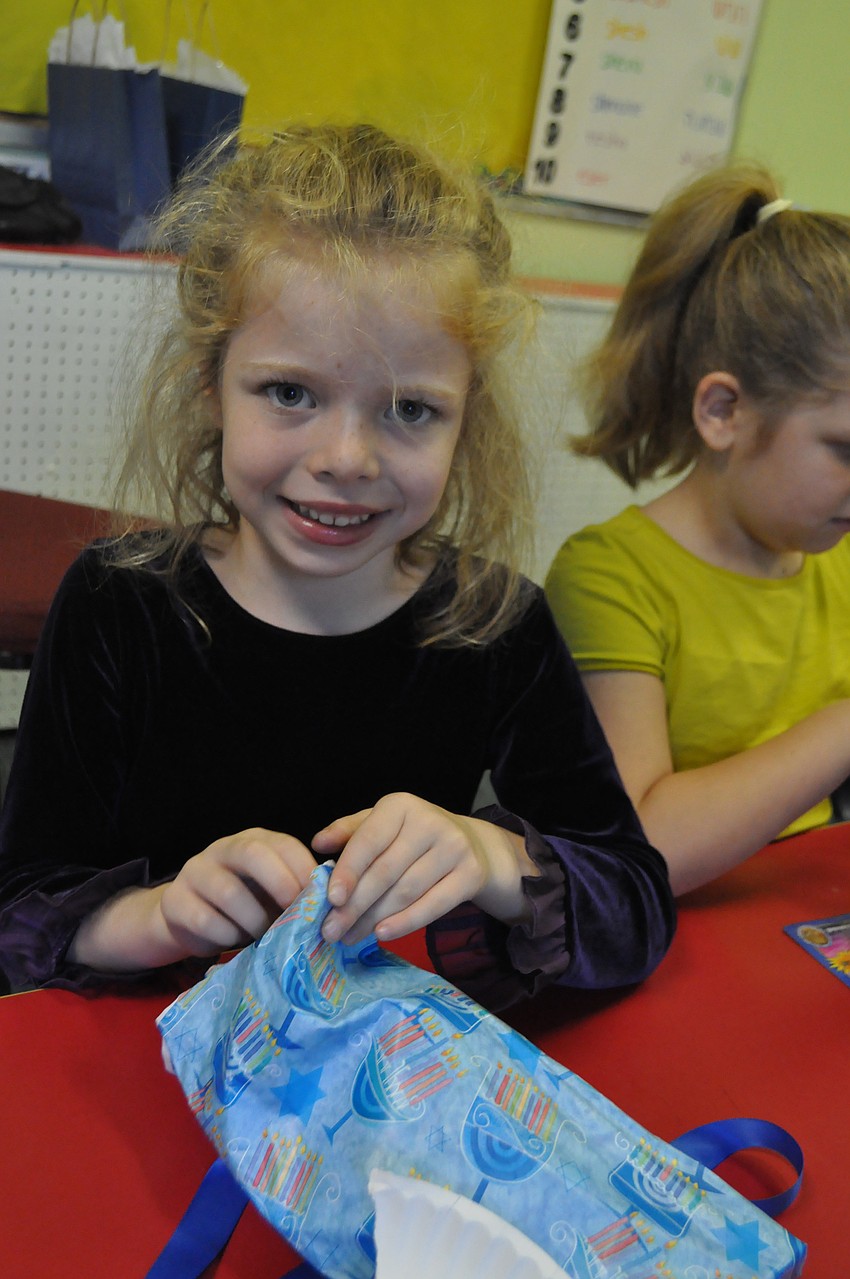 Gabriel Meese unwraps her Hanukah gift.
