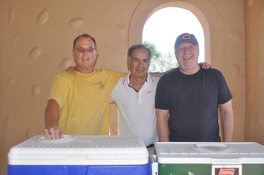 Jim McGuire, Mike Ortega and Mike Nink man the drinks.
