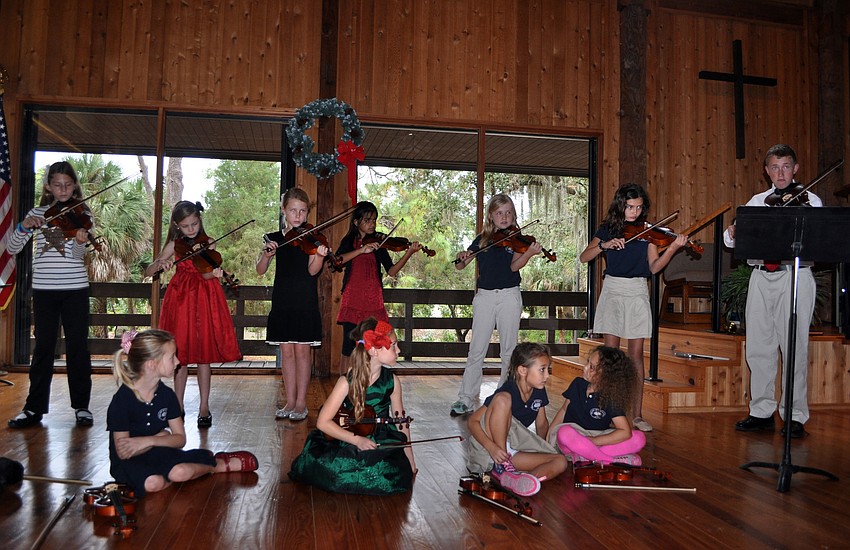The older students perform â€œAndantinoâ€ on their violins Tuesday, Dec. 11, during the Christmas and Holiday Music Fest at Siesta Key Chapel.