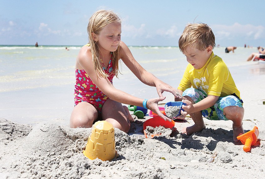 Sydney Schrader and her brother, Kaden, have fun building sand sculptures and castles, Sept. 5, on Siesta Key Beach.