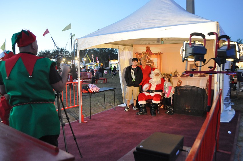 Laila Roegele takes a photo with her mother Linda, grandmother Tiffany, and Santa Claus.