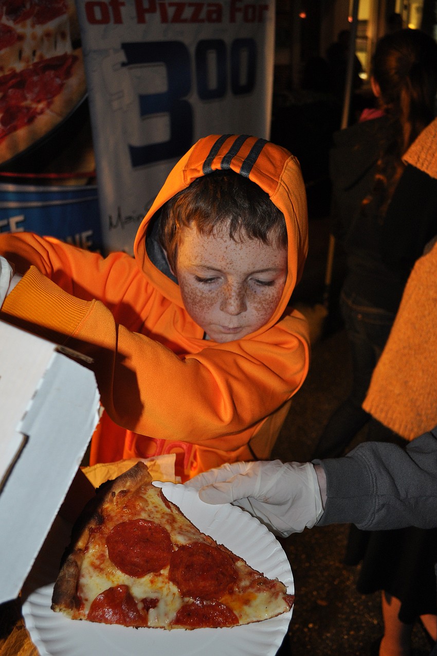 Max Fennessy, 10, helped his mom and sisters serve pizza from the familyâ€™s restaurant, Main Street Trattoria.