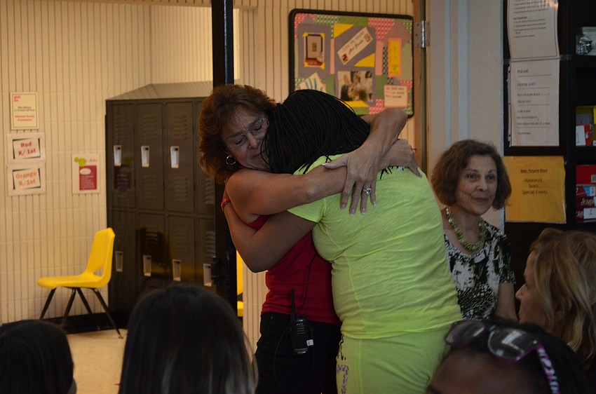 Zandy Sanders hugs and thanks teachers on her way to the stage.