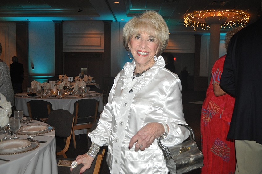 Doris Kaplan models a purse her late husband gave her 61 years ago as a 