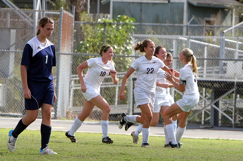 Riverviewâ€™s Kendal Gollnickâ€™s, No. 22, teammates congratulate her on scoring the first goal of the game Saturday, Jan. 12, against North Port at Riverview High School.