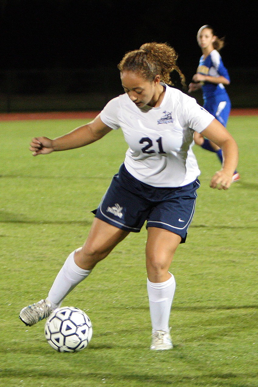 Out-of-Door Academyâ€™s Skylar Junger, No. 21, gets possession of the ball.