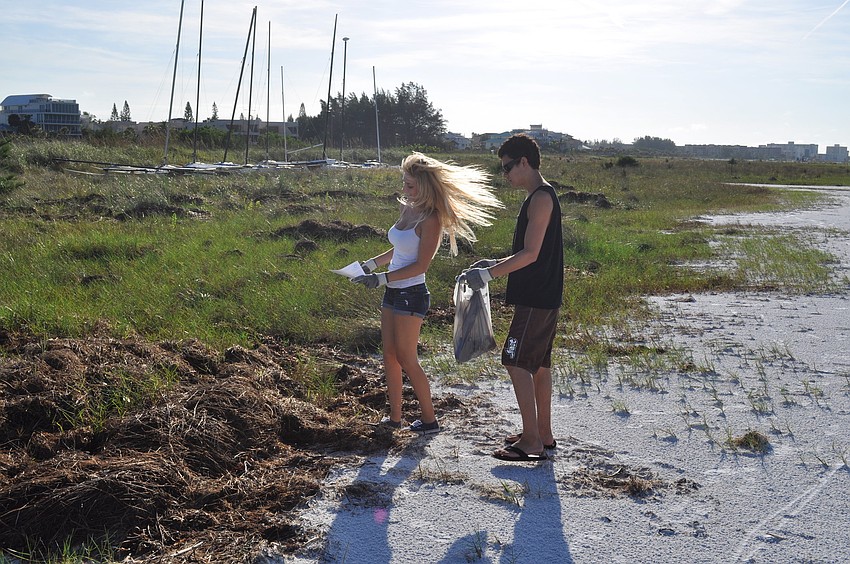 Sophia Dalabakis and David Villa arenâ€™t â€œtoo coolâ€ to wear the Coastal Cleanup volunteer t-shirts. They arrived too late for shirts, but still received gloves and trash bags.