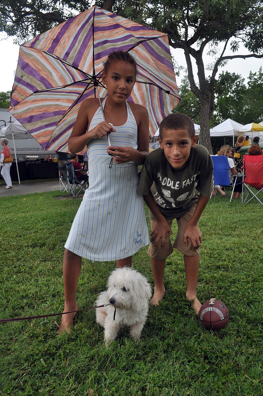 Zakaya and Zion Green pose with their dog, Minnie.