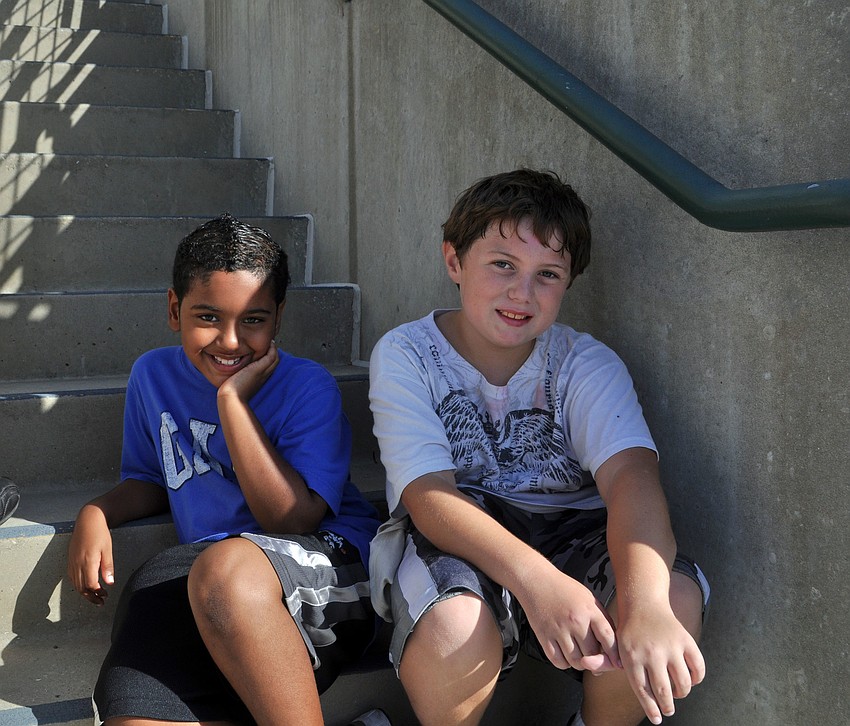 Emanuel Garza and Aden Banberger relax on a staircase after the walk.