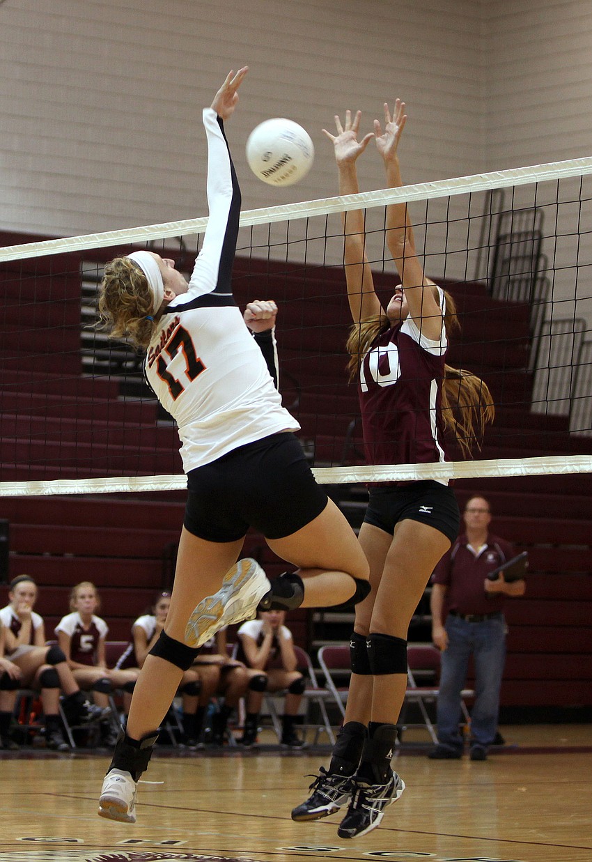 Genevieve Rowe, No. 17, spikes the ball over the net as Ashley Allmer, No. 10, tries to block the ball Monday, Sept. 17 at Riverview High Schoolâ€™s Gymnasium.