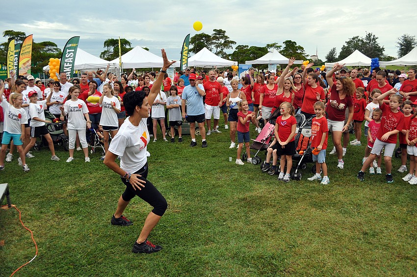 Jennifer Craig from the Sarasota YMCA leads the walkers in a warm up routine.