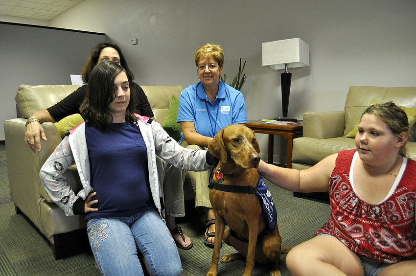 Anita Raynor, her daughter, Kristen, Dianne Frincke and Alyssa Sowa sit with Julie the guide dog.