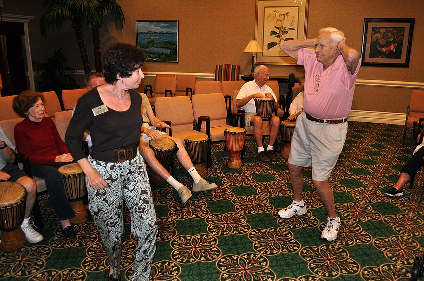 Jill Ross, the director of Masterpiece Living Lifestyle at the Sarasota Bay Club, dances with resident Frank Levine Monday, Sept. 24 during the drum circle event.