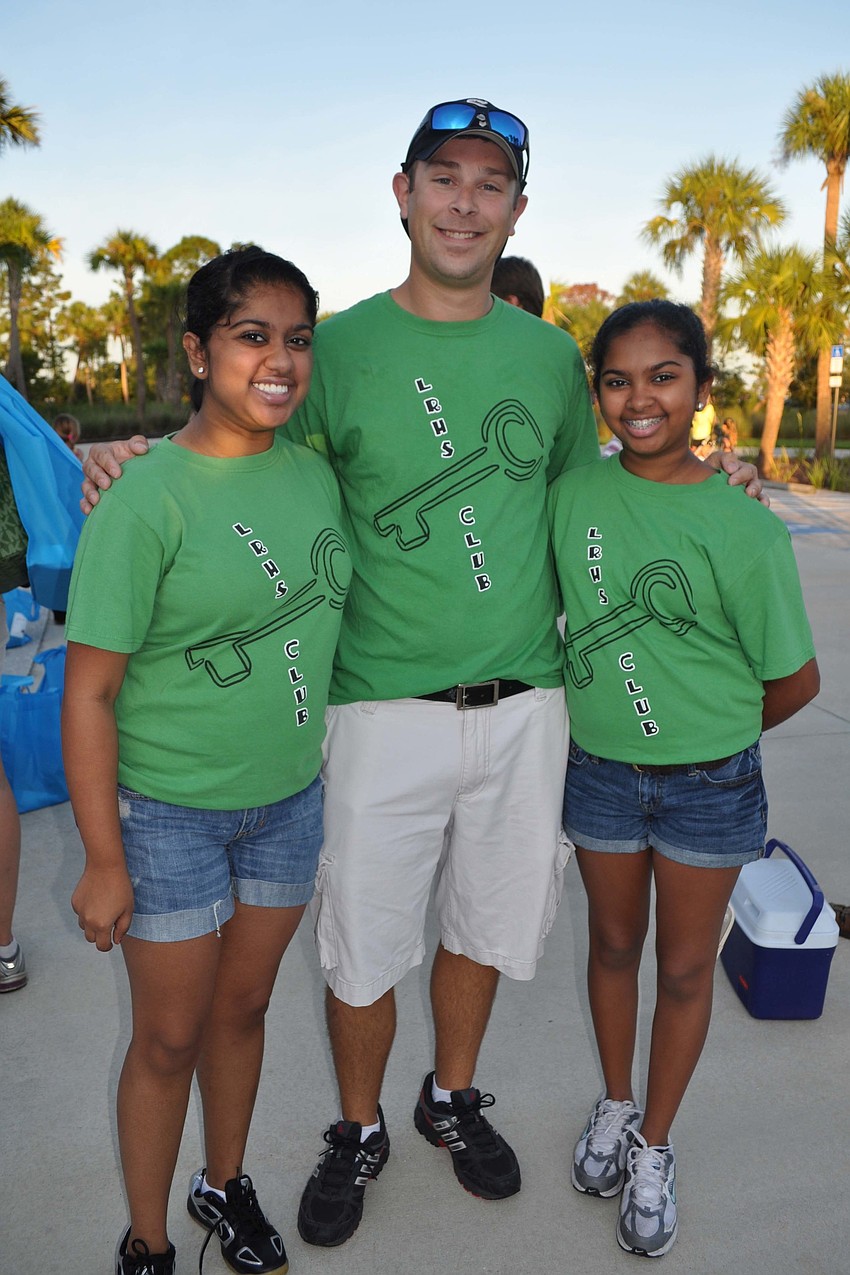Lakewood Ranch High School Key Club Adviser Kevin Merriman, center, volunteered alongside Key Club members Briana and Ariana Rupan.
