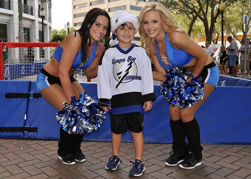 Lightning Girls Megan and Allison pose with Keith McSweeney, 6 Saturday, Sept. 29 during the Tampa Bay Lightningâ€™s Rolling Thunder Tour Sarasota stop at Five Points Park.