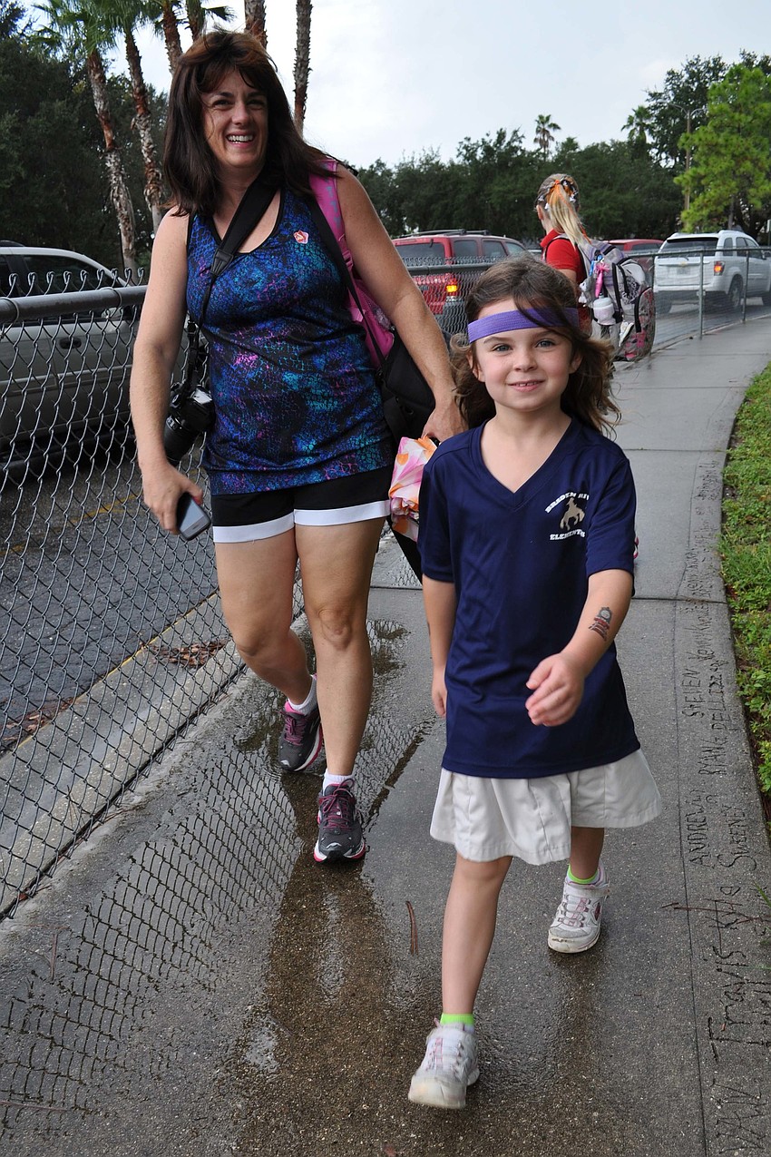 Megan Bovaird, 7, walked with her mom, Jeanette.