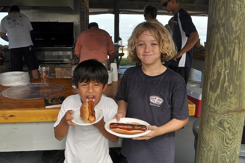 Arlo Hanes, 7, and Victor Vandenbroek, 9, bought hot dogs for lunch at the Sarasota Sailing Squadron Saturday, Oct. 6, during the big garage sale.