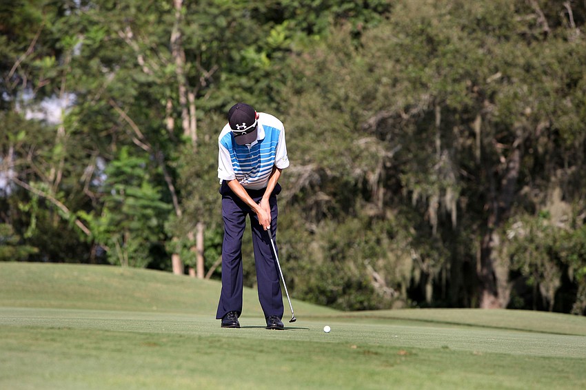 Charles Wang, 15, of Sarasota Christian, putts during the golf match Tuesday, Oct. 7, out at Bent Tree Country Club. Wang had the best score of the day with 35.