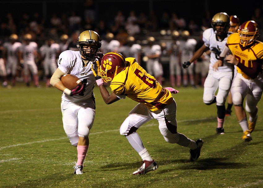 Brannon Slater, No. 4, tries to run the ball down the field while Sean Morris, No. 6, tries to stop him from getting too far.