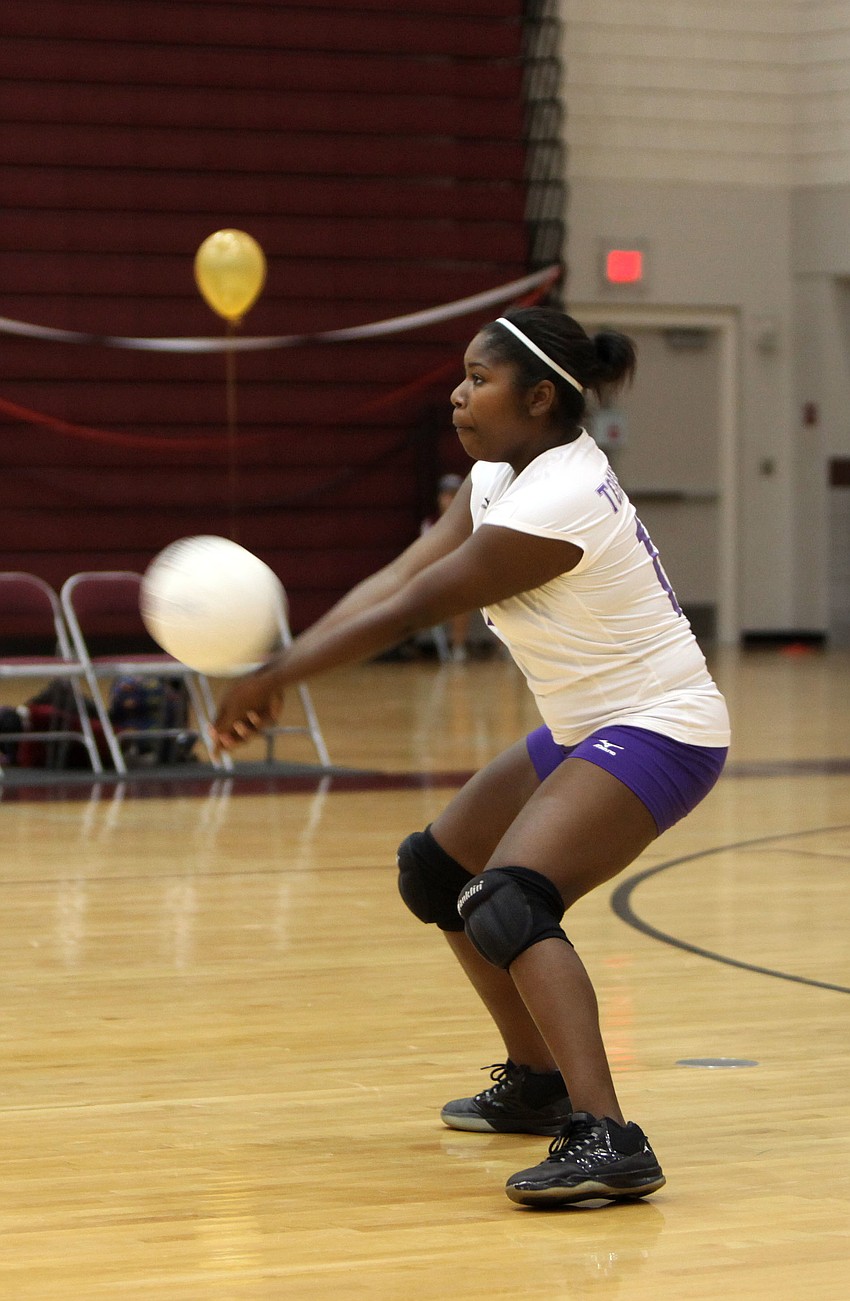 Kellisha Bellamy, No. 12, bumps the ball.