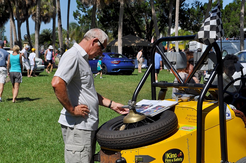 Robert Graham reads the details about one of the display cars