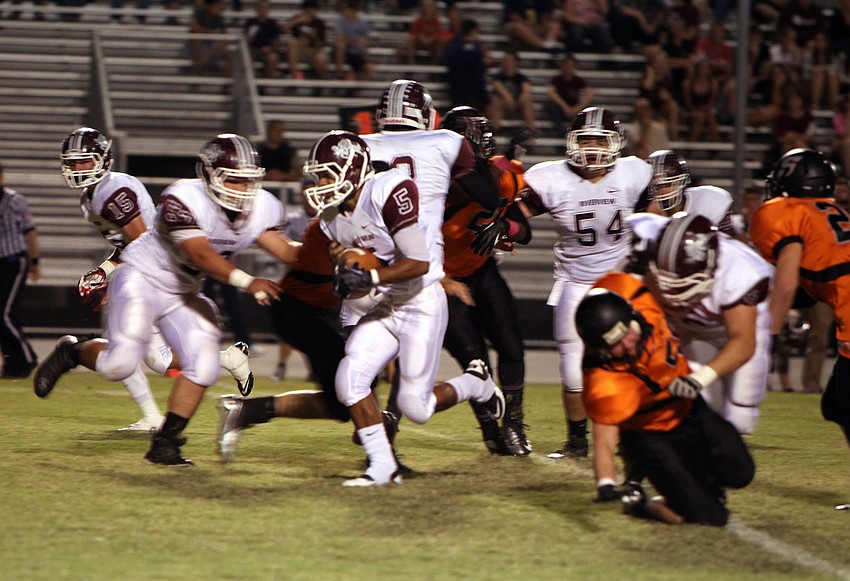 Jaden Adams, No. 5, runs down the field with the ball.