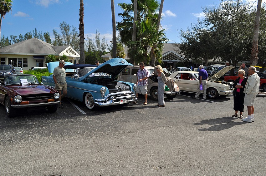 People have fun looking at antique cars in the Centre Shops parking lot.