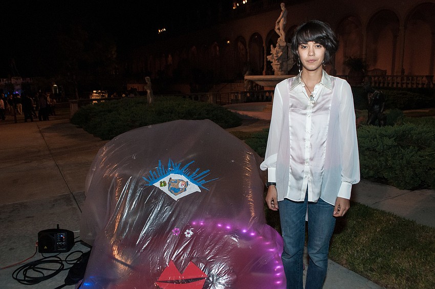 Sarah Valdez stand next to her work Hobby Lobbiests.