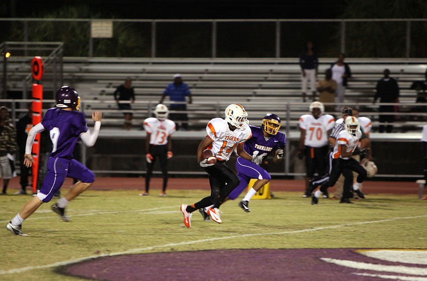 Joe Williams, No. 14, tries to out run the Tornadoes.
