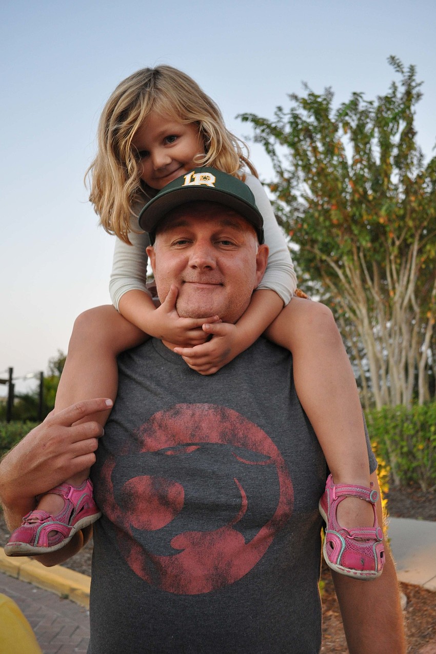 Sadie Fletcher, of Lakewood Ranch, got a good view from the shoulders of her dad, Don.