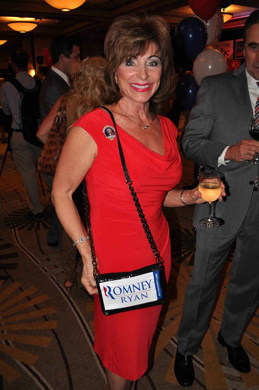 Holly Derrick shows off her purse that she decorated with a Romney Ryan sticker.