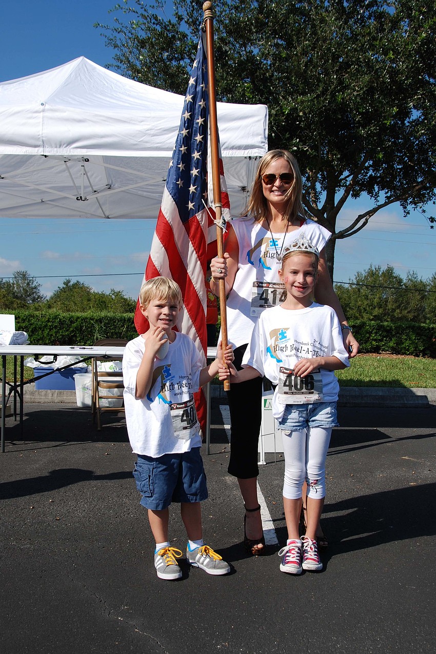 Hayden Hornback, 5, Estella Hornback, 7, and Cynthia Hornback smile for a picture as they get ready for the High-Heel-A-Thon to begin.