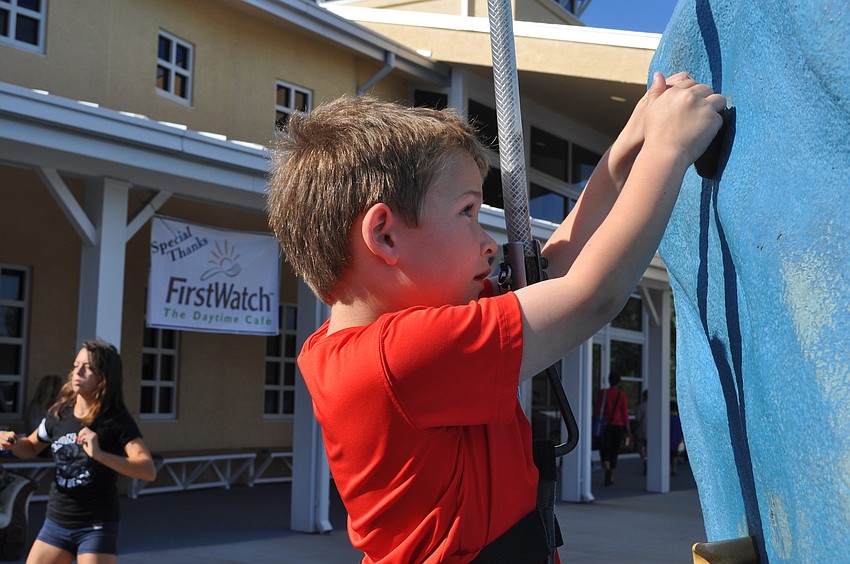 Sam Schoenfeld climbed the rock wall.