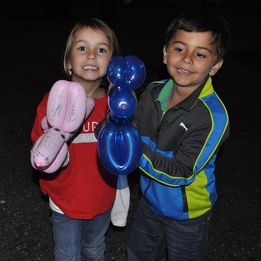 Nina Fitzgerald and Connor Dzembo held balloons.