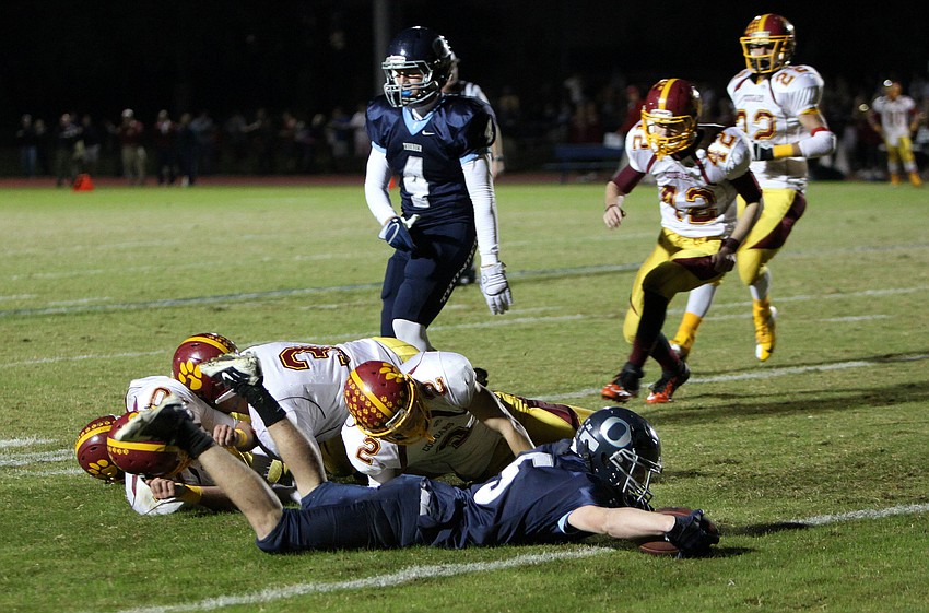 Drew Fineberg, No. 5, holds onto the ball after being tackled.