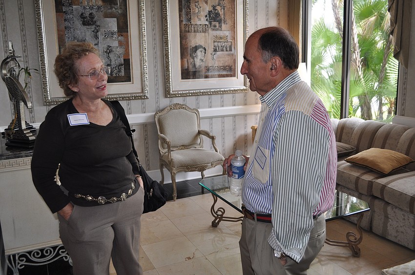 Nancy Eisenstat and Sy Klionsky chat with one another before the meeting.
