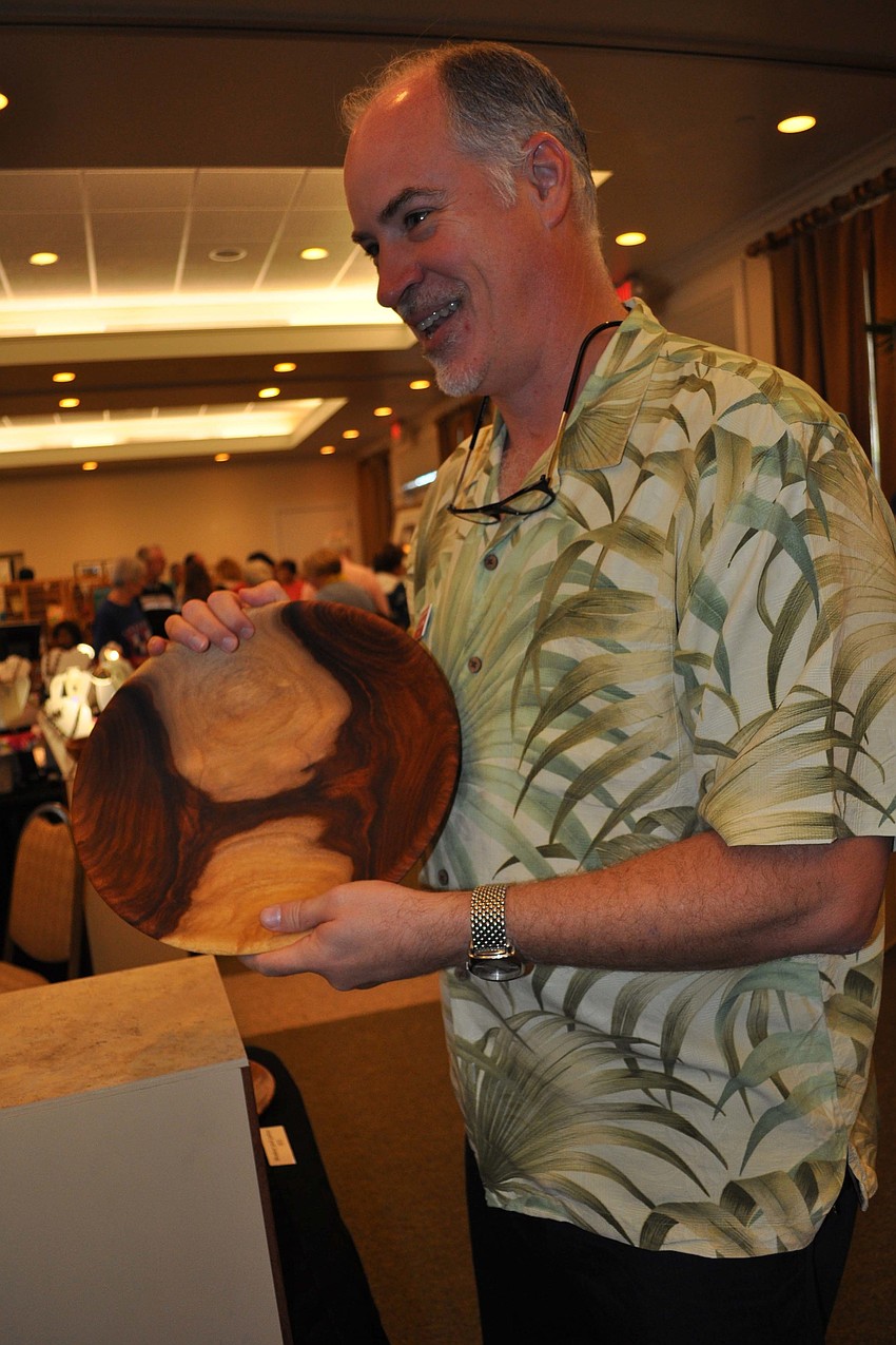 Jim O'Donnell showed patrons a wooden salad bowl.
