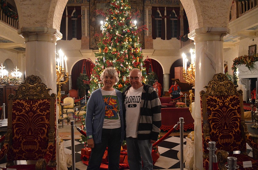 Janet and Denny Templeton stand in front of a 14 ft Christmas tree with hand blown glass ornaments from Germany.