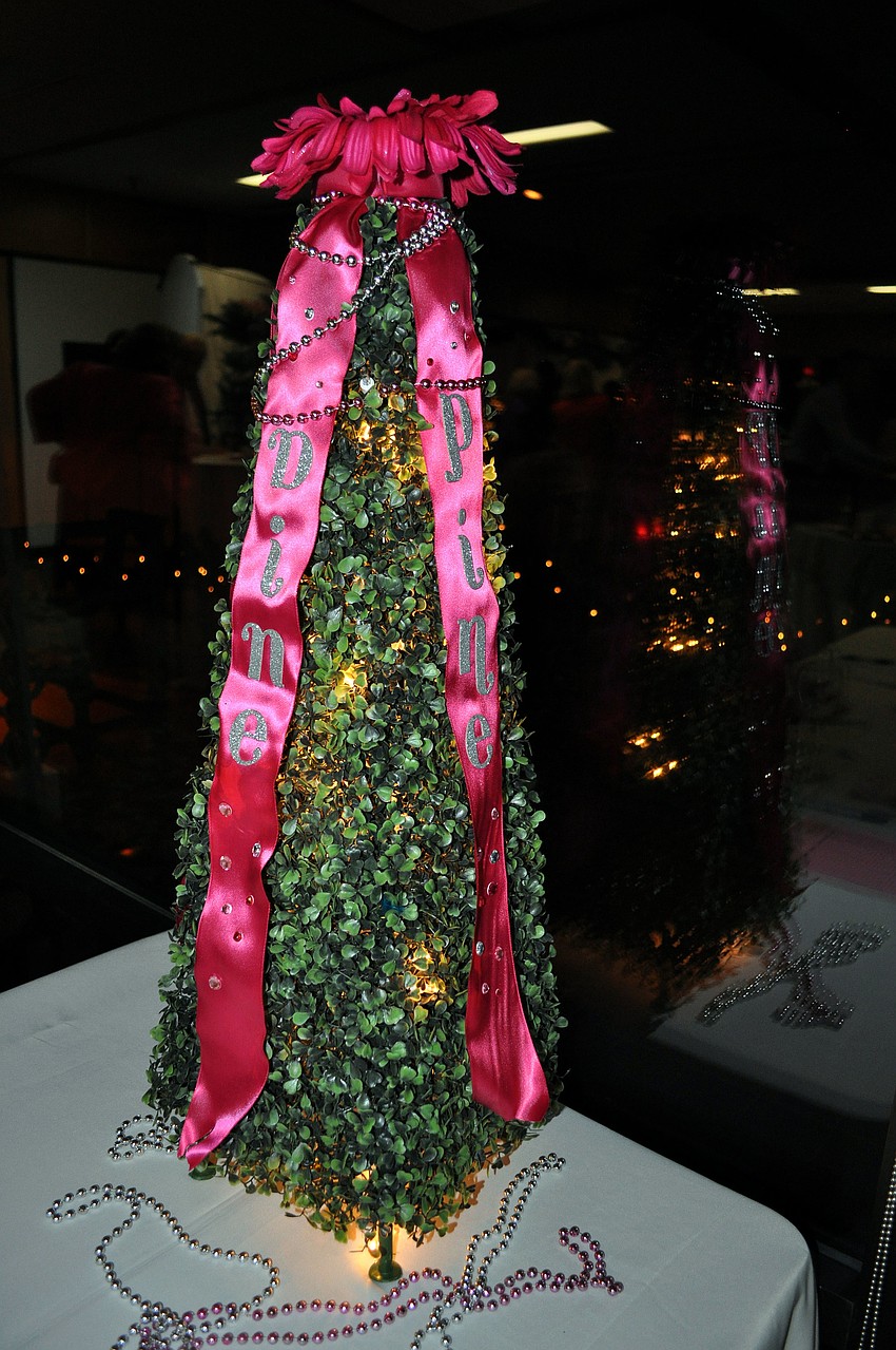 A small tree at the front door was decorated with pink ribbons spelling out the name of the event.