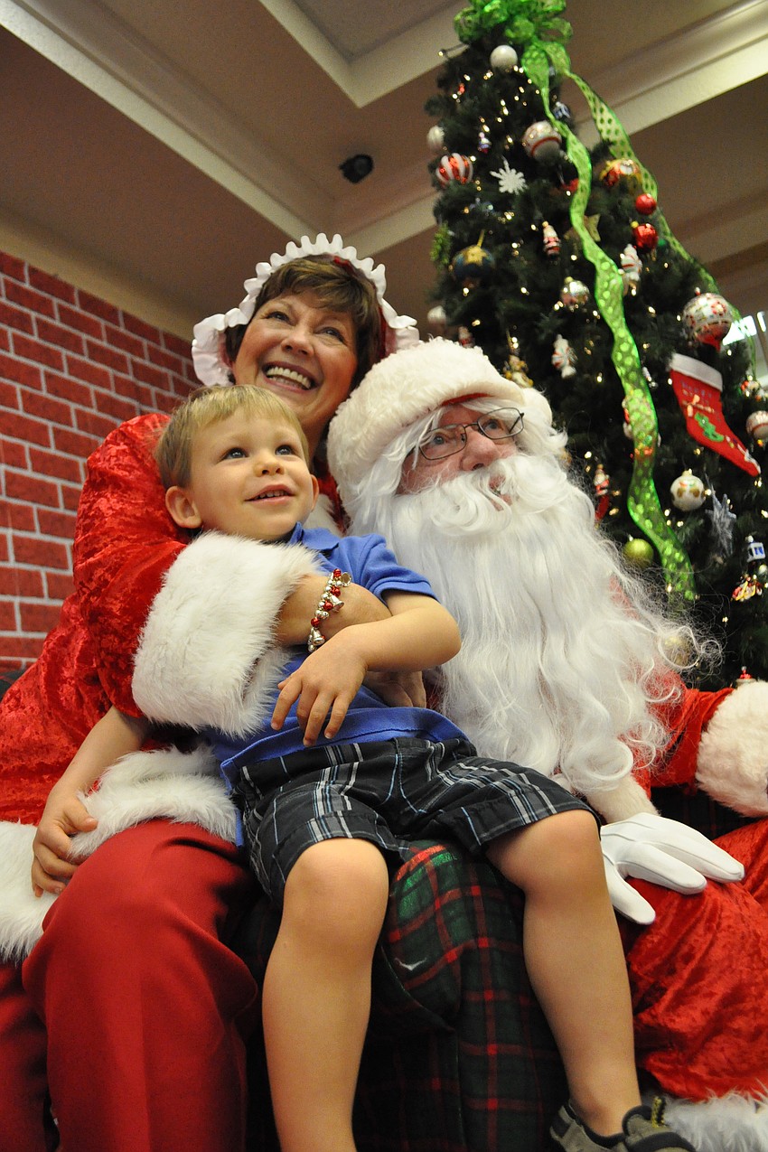 Zachary Roy, 2, was all smiles during his visit with Mrs. and Mr. Claus, portrayed by Jeanne and John Larranaga.