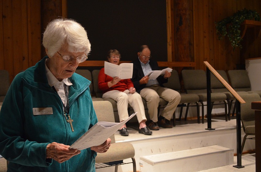 Dr. Margaret Towner, Mickey and Alan Shoop sing Christmas songs in the choir.