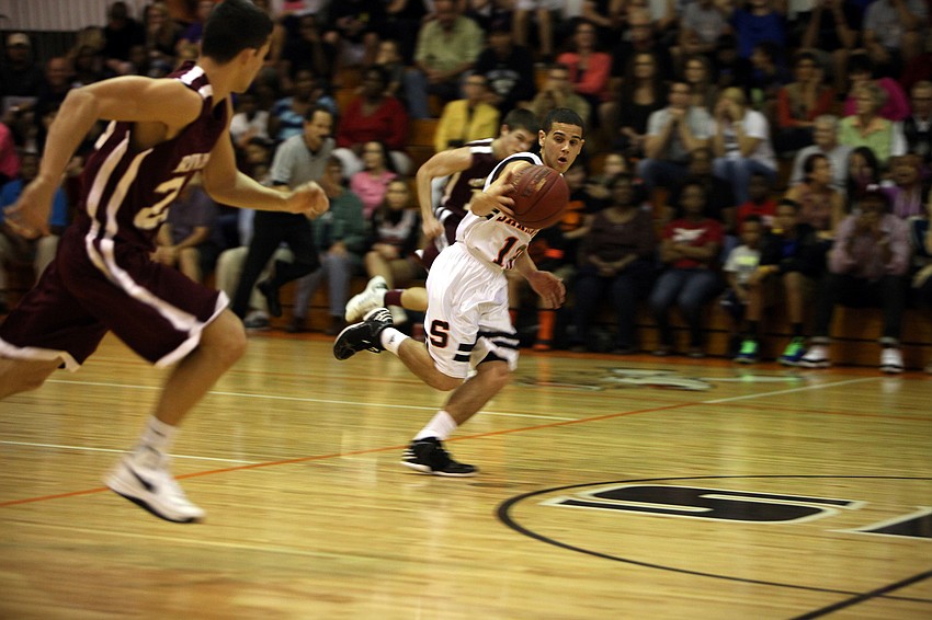 Sarasotaâ€™s Justin Robbins, No. 13, steals the ball and runs up the court towards the basket during Riverviewâ€™s game against Sarasota Monday, Dec. 3, at Sarasota High School.