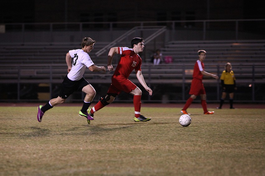 Cardinal Mooneyâ€™s Andrew Abrams, No. 15, runs down the field with the ball as Bookerâ€™s Eric Guendl, No. 23, tries to steal the ball back.