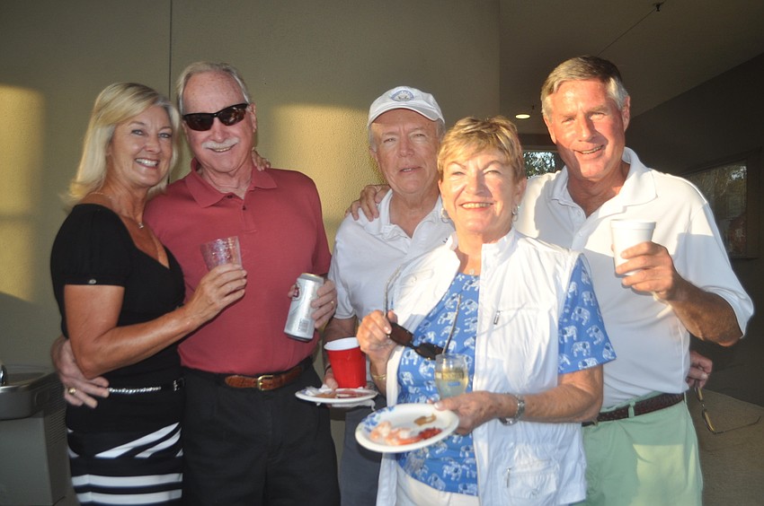 Linda Gillott, Rich McGrath, Steve Sills, Karen Sawyer and Andy Sawyer pose after enjoying a bite at the kickoff party. The group included three formidable left-handed players, Andy Sawyer said.