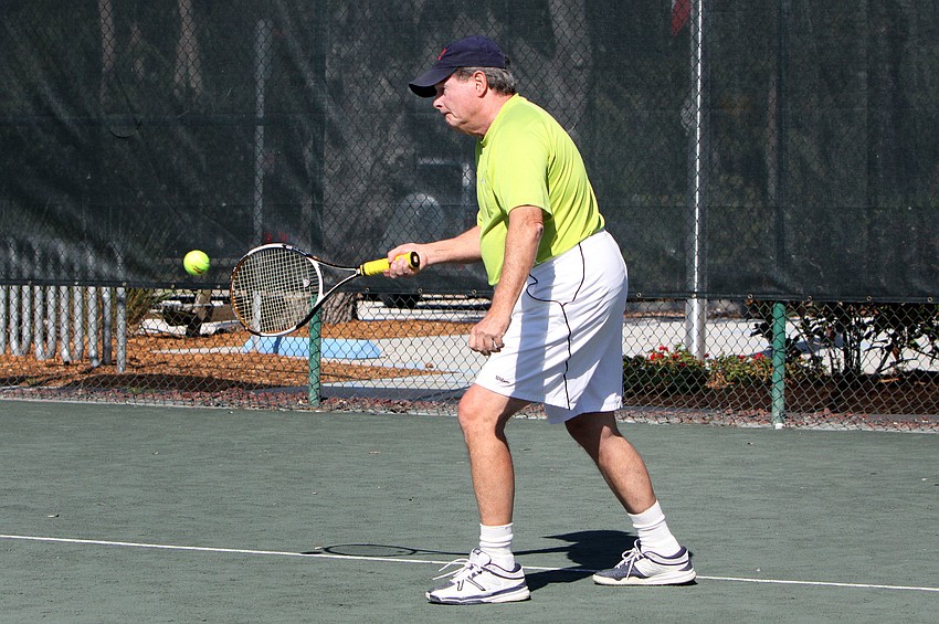 Walter Hackett hits an easy forehand during his doubles match Friday, Dec. 7, at the Longboat Key Public Tennis Center.
