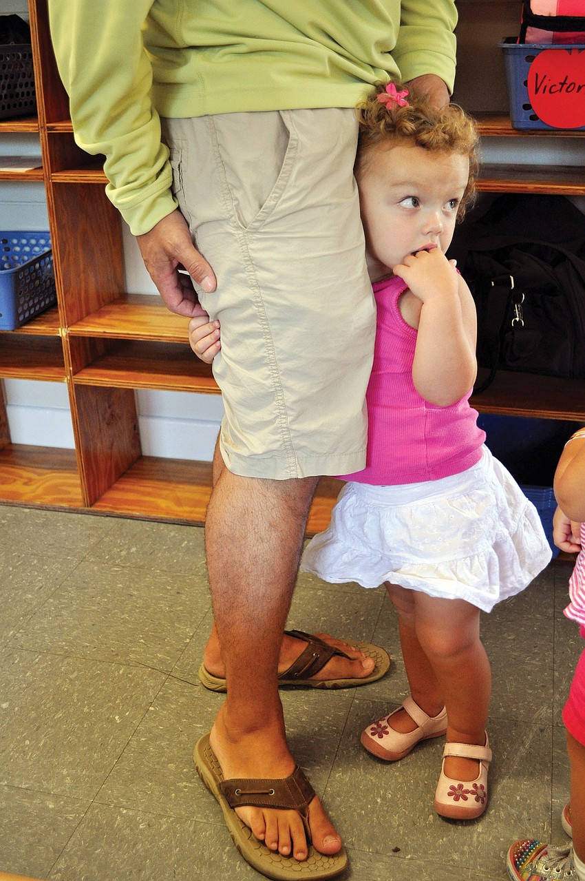 Keira Pritchett, 2, clings to her dad, Josh, on the Aug.20 the first day of school at St. Boniface Preschool.