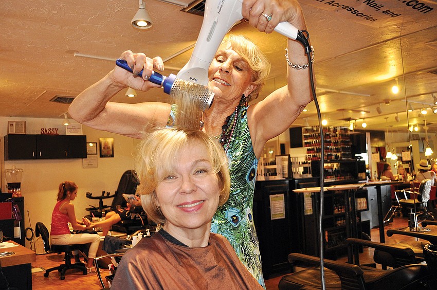 Bobbie Tuccinardi styles Gail Emmottâ€™s hair, Oct. 14, during the Martinis and Makeovers event hosted by Foxy Lady Siesta and Sassy Hair Salon on Siesta Key.