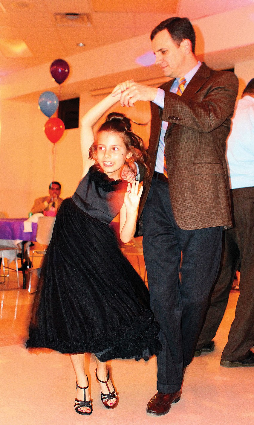 Charlie Bailey twirled his daughter, Claire, 7, during a dance at the â€œWilly Wonka and the Chocolate Factoryâ€-themed father/daughter dance at St. Martha Catholic Church.