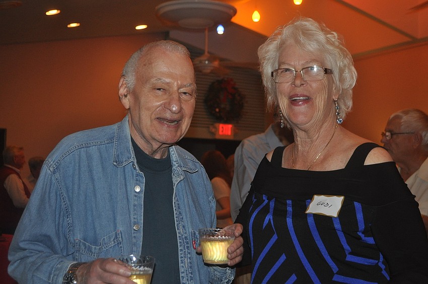 Ron Rosenthal and Gudi Swanson enjoy drinks and laughs at the holiday party.