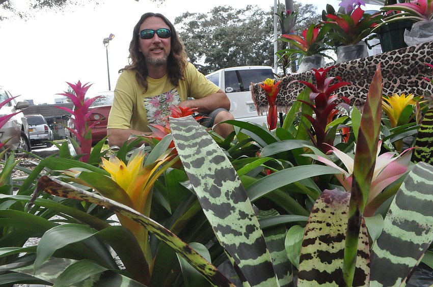 Jason Mellica sells colorful bromeliad.